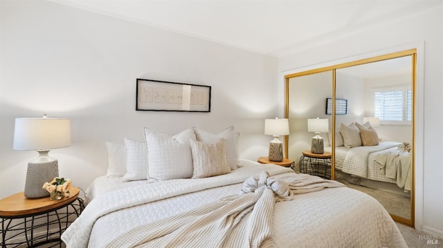 bedroom featuring carpet flooring and a closet