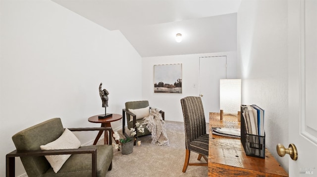 sitting room with carpet flooring and vaulted ceiling