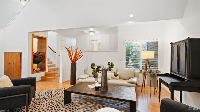 living room featuring light hardwood / wood-style floors and lofted ceiling