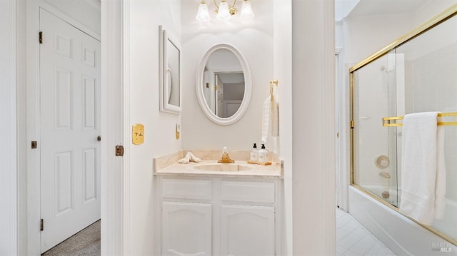 bathroom with combined bath / shower with glass door and vanity