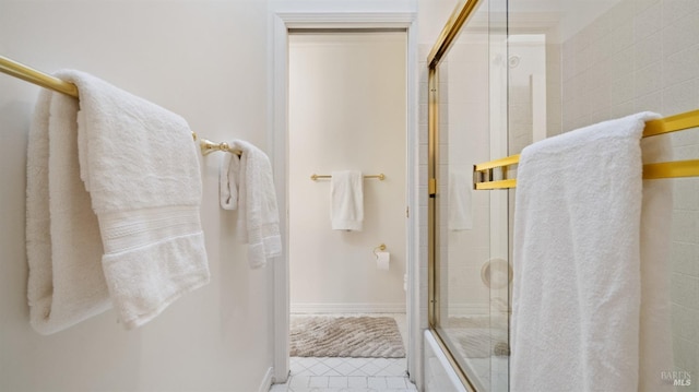 bathroom with bath / shower combo with glass door
