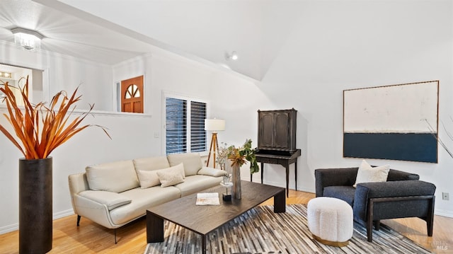 living room featuring ornamental molding and light wood-type flooring