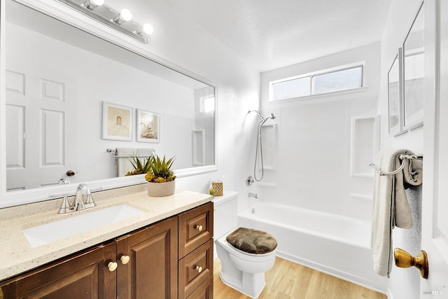 full bathroom with vanity, shower / tub combination, hardwood / wood-style flooring, toilet, and a textured ceiling