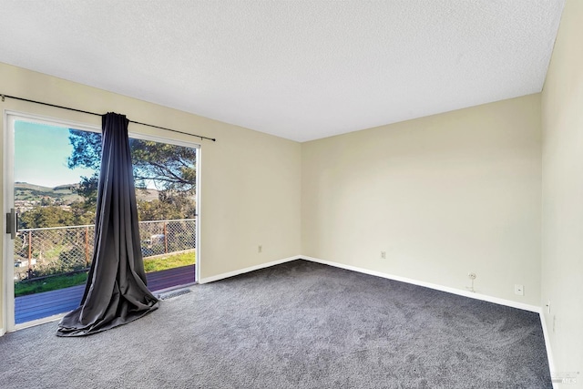 carpeted spare room with a textured ceiling