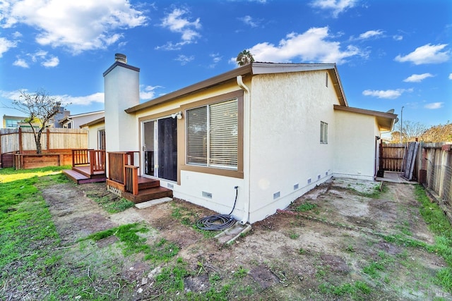 back of house featuring a deck