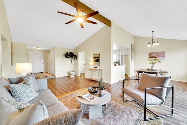 living room with beamed ceiling, ceiling fan with notable chandelier, wood-type flooring, and high vaulted ceiling