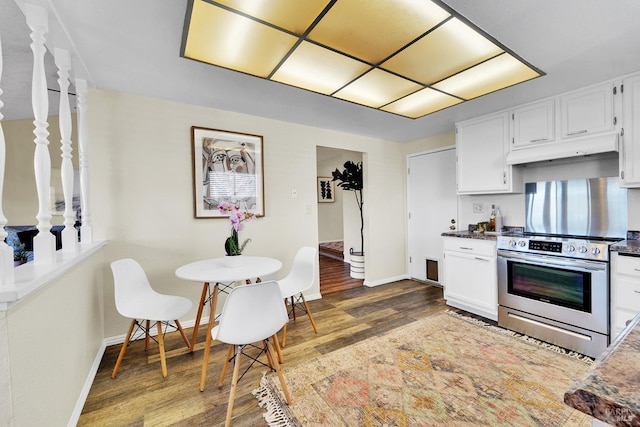 kitchen featuring white cabinets, dark hardwood / wood-style floors, and stainless steel electric range