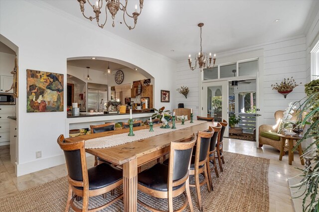 dining room featuring ornamental molding and a notable chandelier