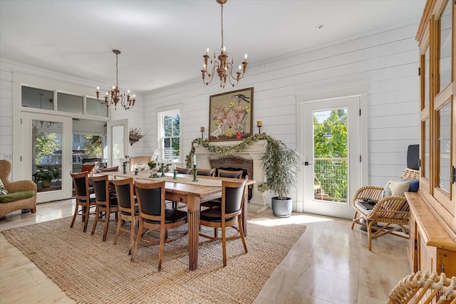 dining room featuring a fireplace and an inviting chandelier