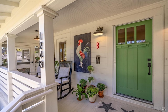 doorway to property featuring covered porch