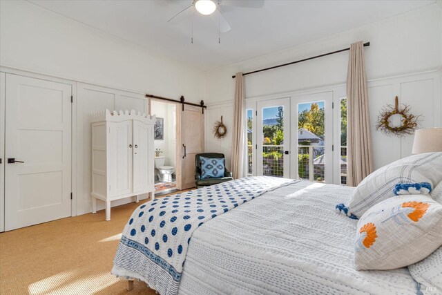 carpeted bedroom with access to outside, ceiling fan, and wood walls