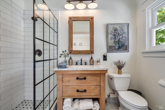 bathroom with toilet, a walk in shower, and vanity