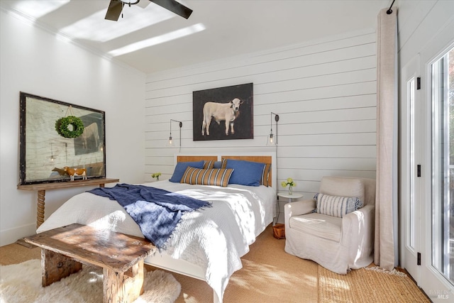 bedroom featuring wooden walls and a ceiling fan