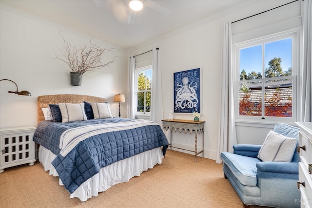 bedroom featuring baseboards, radiator, light colored carpet, and crown molding