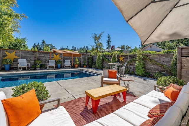 view of pool with a patio area, a fenced backyard, an outdoor living space, and a fenced in pool