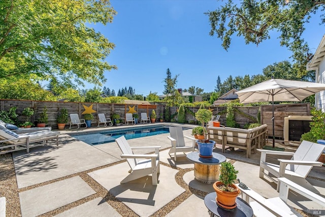 view of swimming pool featuring a fenced backyard, a fenced in pool, and a patio