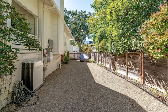 view of property exterior with a patio area, a fenced backyard, and central AC