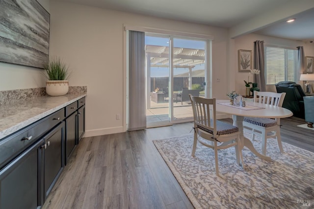 dining area featuring a healthy amount of sunlight and light wood-type flooring