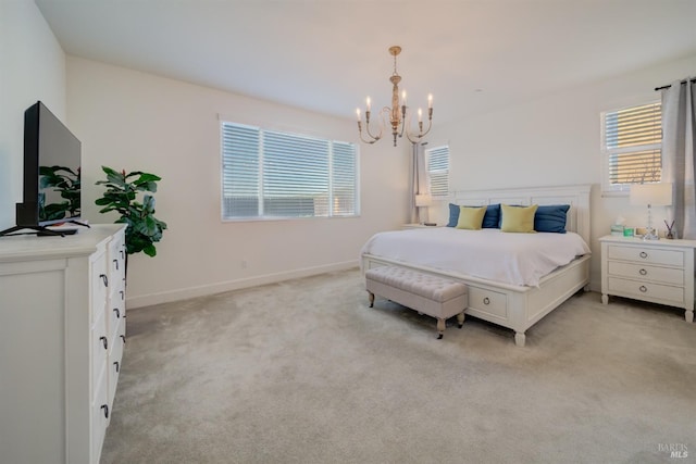 carpeted bedroom with an inviting chandelier