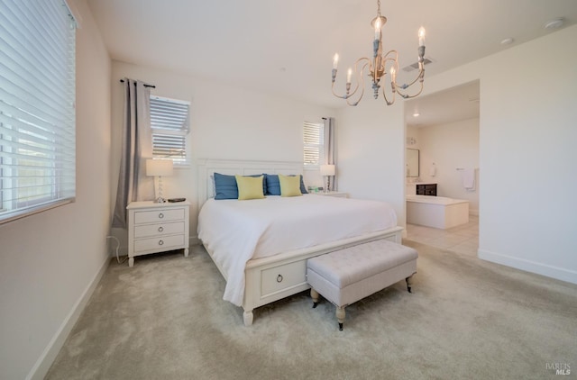 carpeted bedroom featuring an inviting chandelier and ensuite bathroom