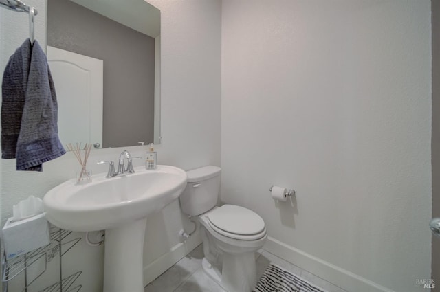 bathroom with tile patterned floors and toilet