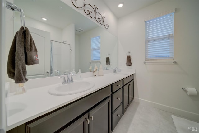 bathroom featuring an enclosed shower, vanity, and tile patterned flooring