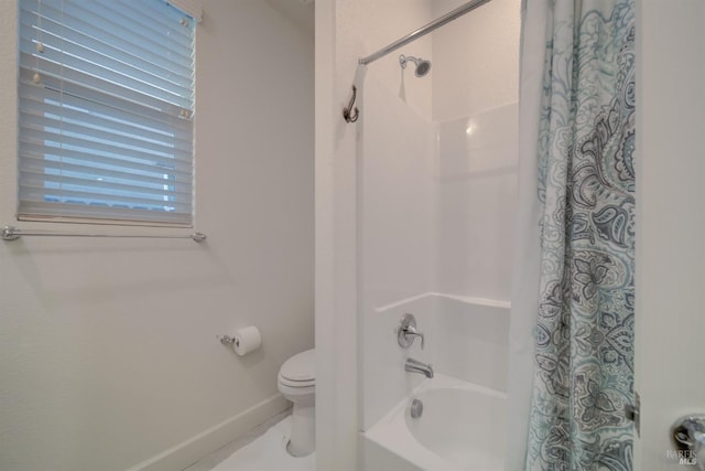 bathroom featuring shower / bath combo and toilet