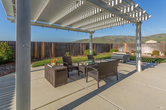 view of patio featuring a mountain view, a pergola, and an outdoor hangout area