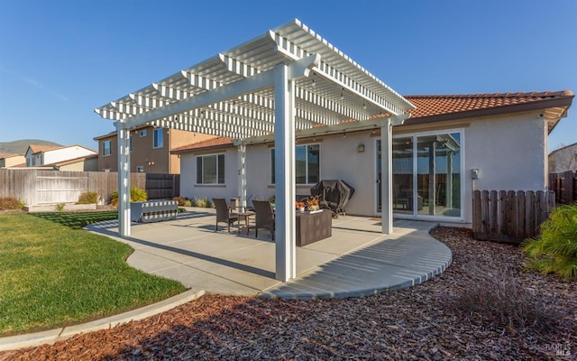 rear view of property with a patio, a yard, and a pergola