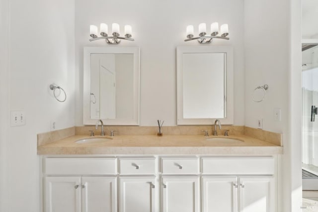 full bathroom with double vanity and a sink