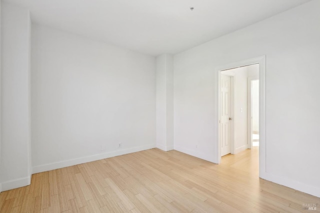 unfurnished room featuring light wood finished floors and baseboards