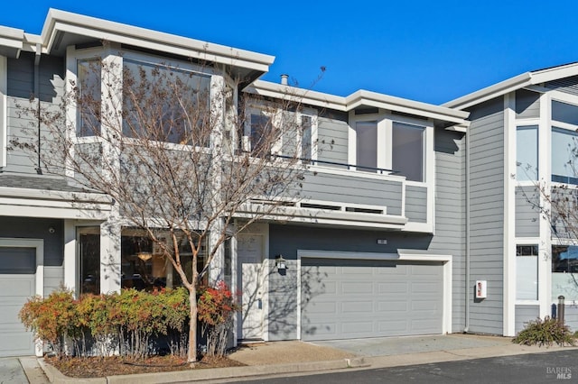 multi unit property with an attached garage and a balcony