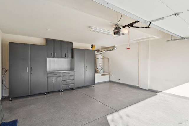 garage featuring a garage door opener and water heater