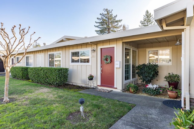 entrance to property with a lawn