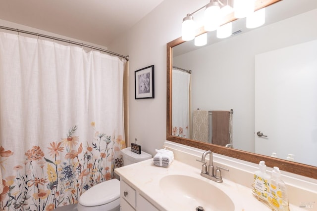 bathroom with vanity, toilet, and walk in shower