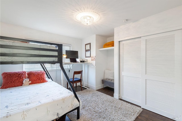 bedroom featuring dark hardwood / wood-style flooring and a closet