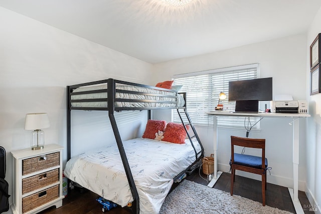 bedroom with dark hardwood / wood-style floors