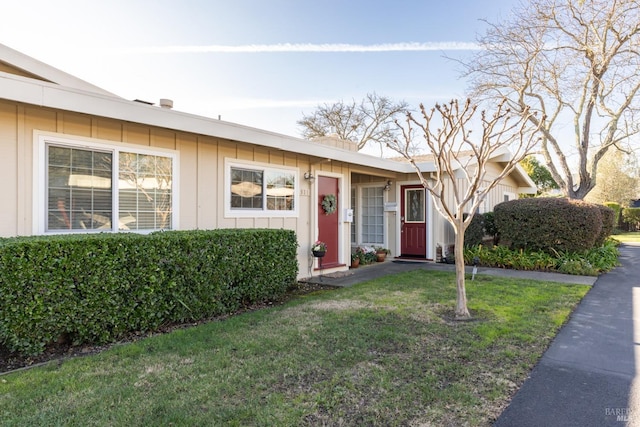 single story home featuring a front yard