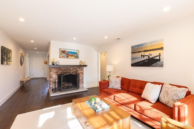 living room with dark hardwood / wood-style floors and a brick fireplace