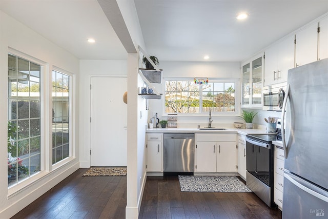 kitchen featuring dark hardwood / wood-style flooring, white cabinetry, sink, and stainless steel appliances