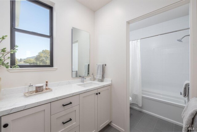 full bathroom featuring vanity, tile patterned flooring, toilet, and shower / bathtub combination with curtain