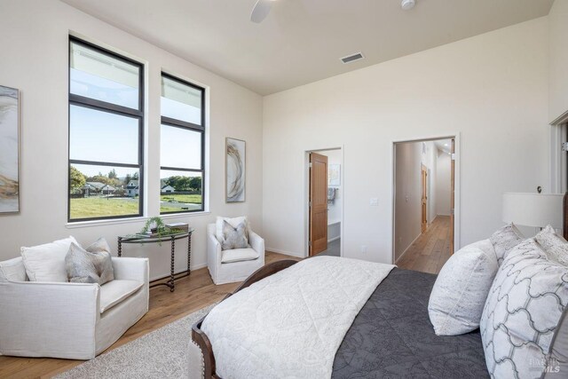 bedroom featuring visible vents, ceiling fan, and wood finished floors