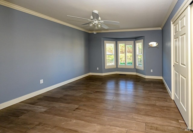 empty room with ceiling fan, crown molding, and hardwood / wood-style flooring