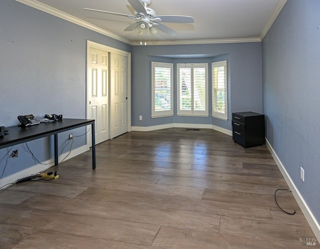 unfurnished room featuring ceiling fan, crown molding, and wood-type flooring