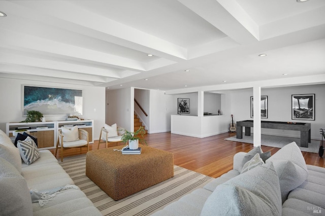 living room featuring hardwood / wood-style floors and beamed ceiling