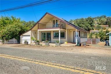 view of front of house with a balcony and a garage