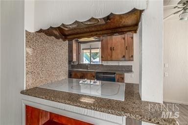 kitchen with dishwasher, tasteful backsplash, and white cooktop