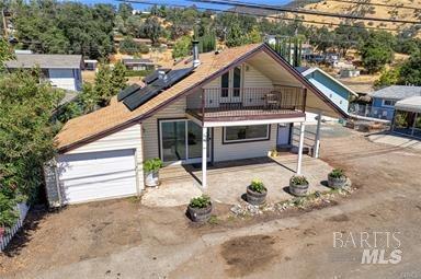 view of front of home featuring a garage and a balcony