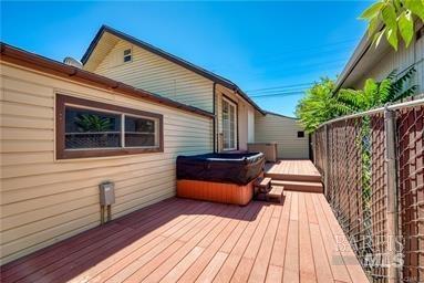 wooden terrace with a hot tub