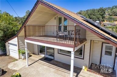 rear view of property with a balcony